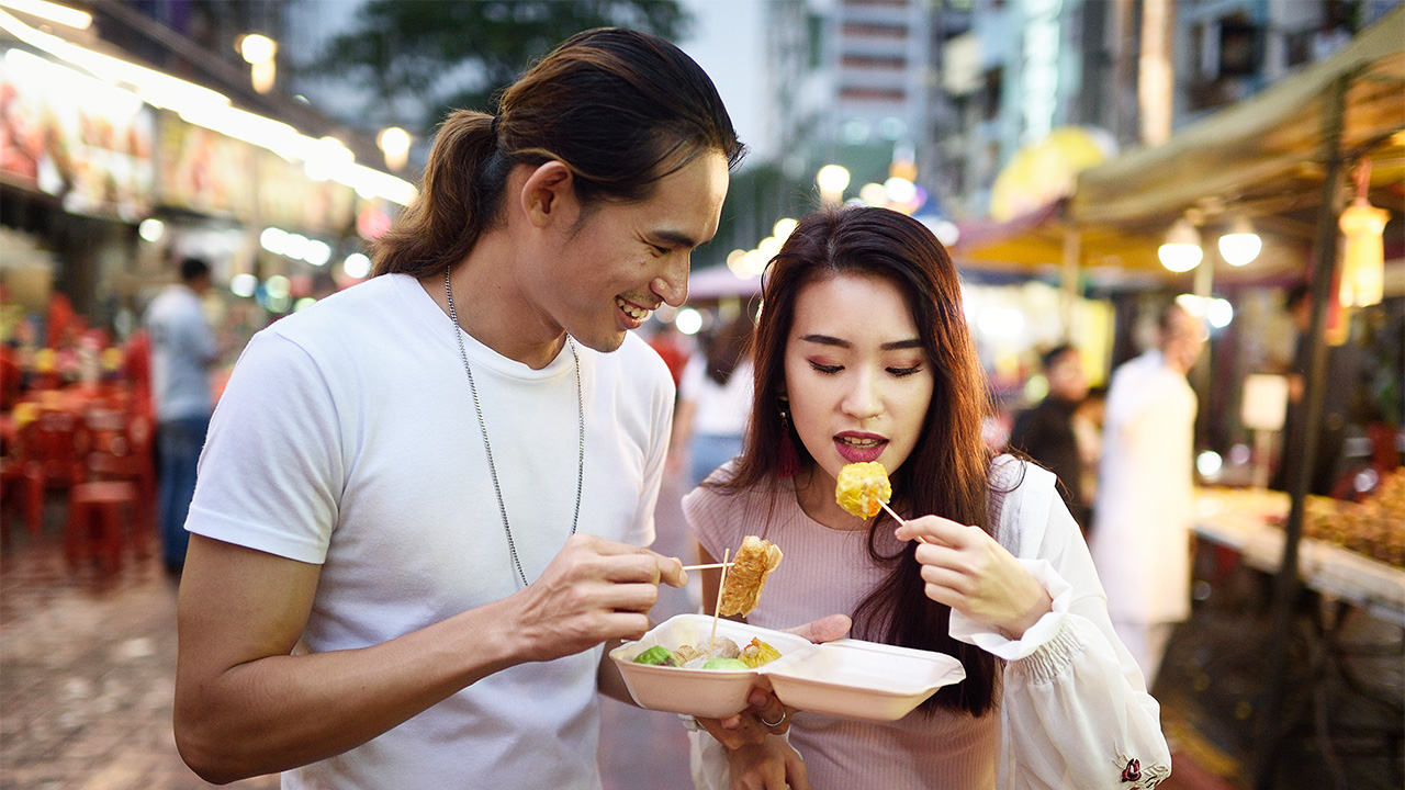 Couple sharing street food