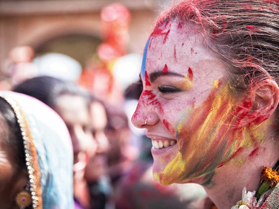 Happy young woman celebrating Holi in India