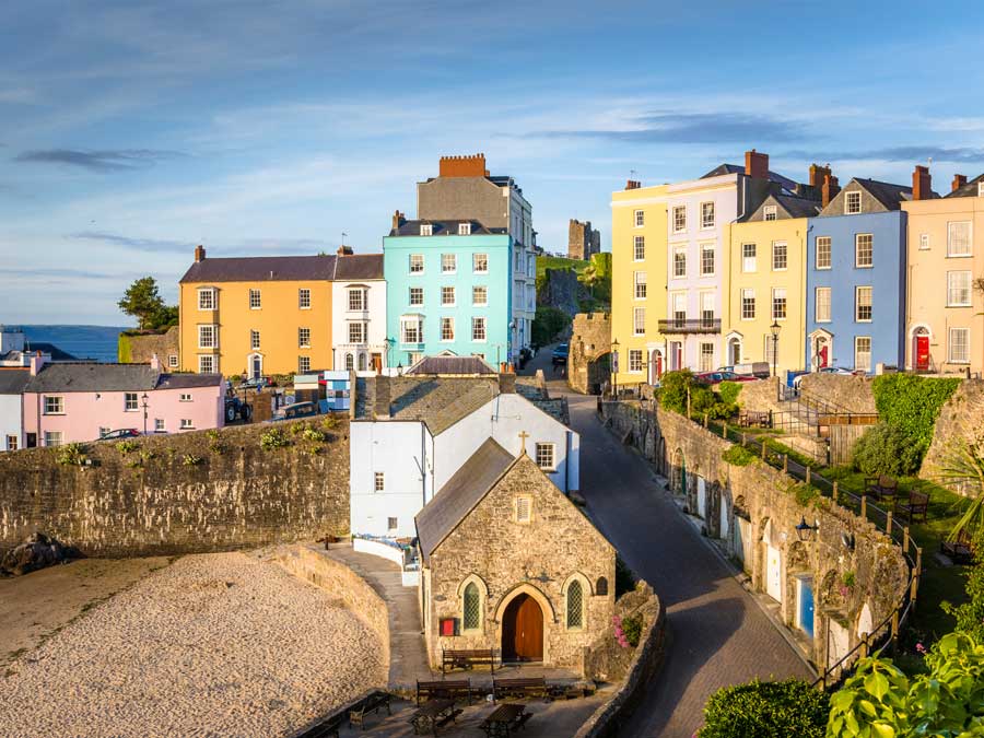 Pastel Coloured Town Houses overlooking the Harbour at Sunset. Tenby, Wales, UK.