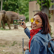 Woman smiling and taking a photo at the zoo
