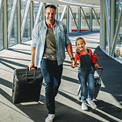 Parent and child walking through the airport