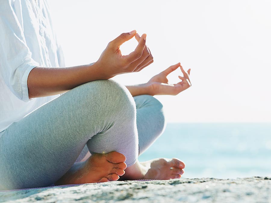 Doing yoga by the beach