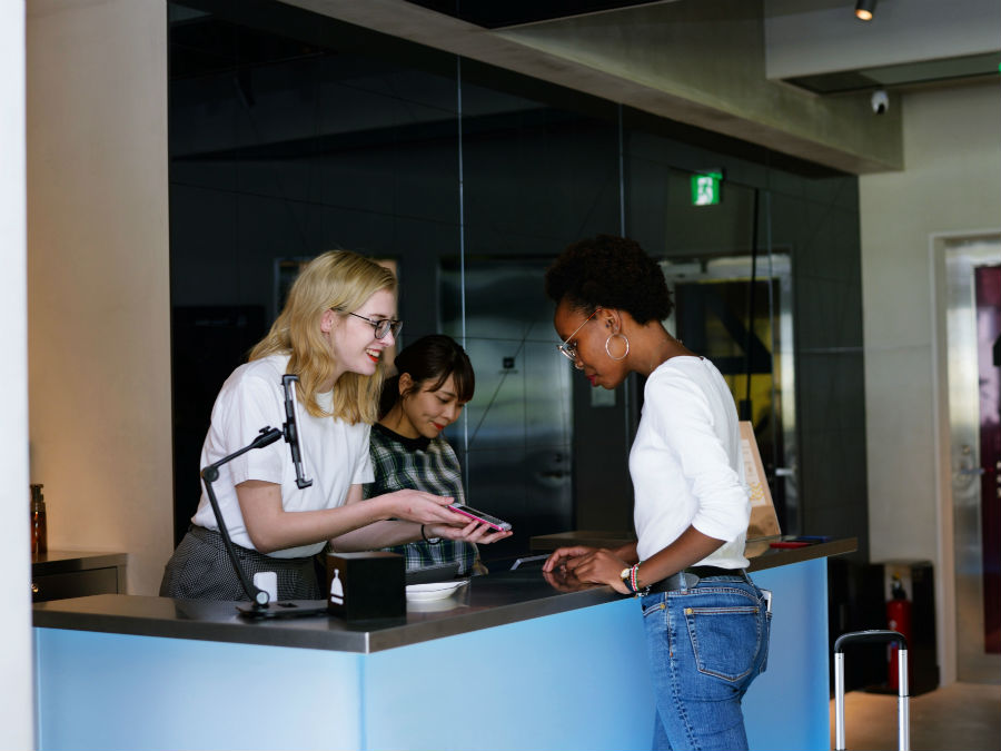 Woman checking in at hostel