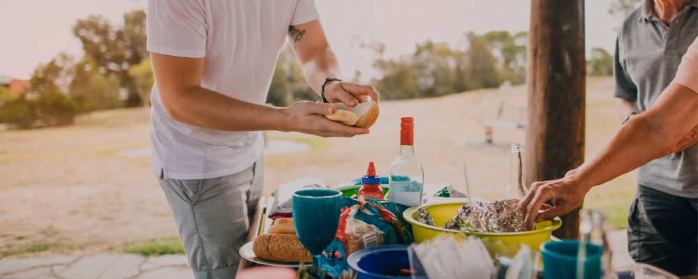 Couple preparing food on a picnic table