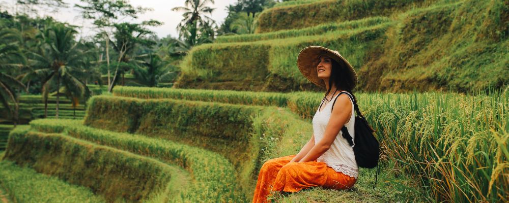Woman sitting in rice fields