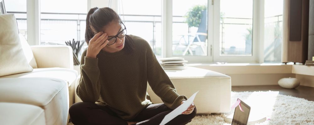 Woman looking at paper at home