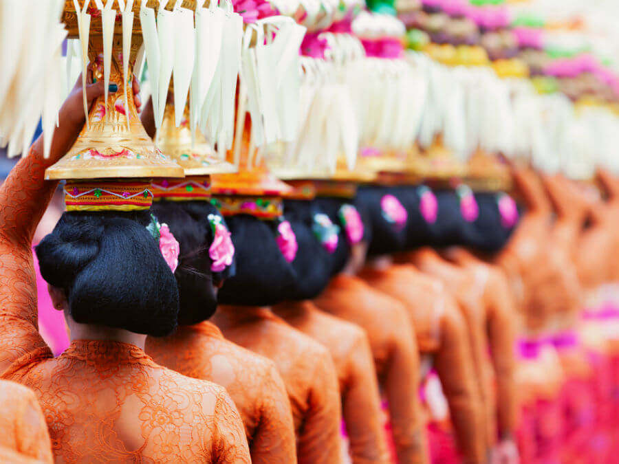 Local women carrying ornaments on their head at a Bali festival