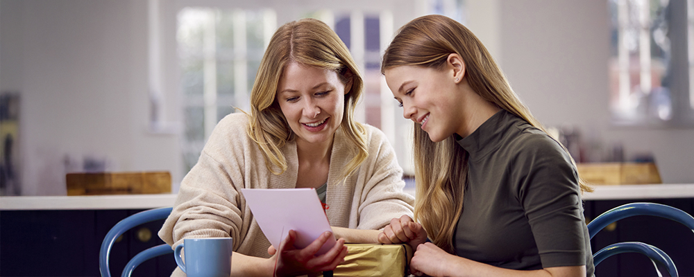 Mother and daughter looking at document