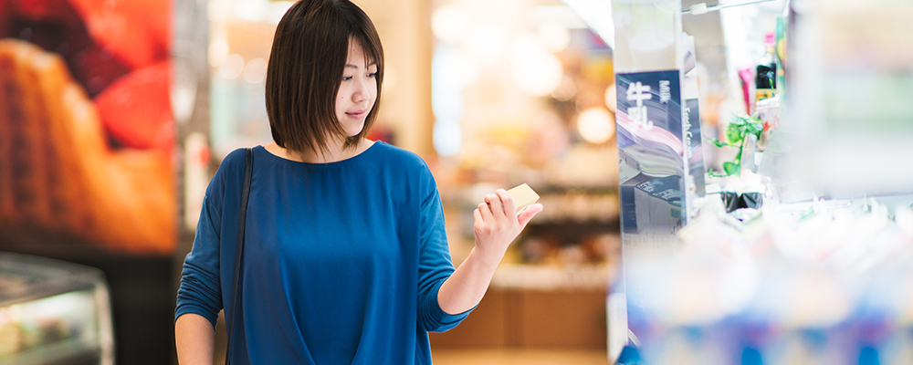 Woman looking at produce inside supermarket